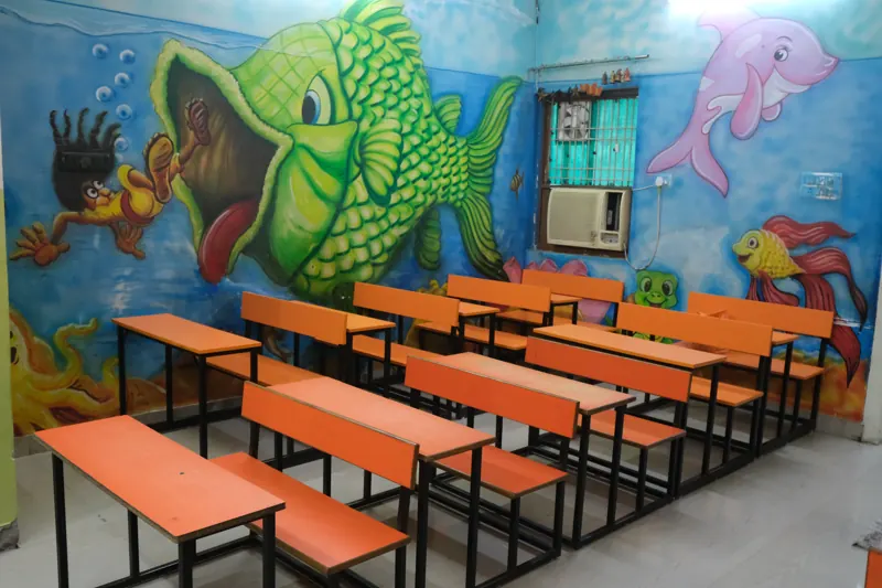 Classroom with orange benches and an underwater mural