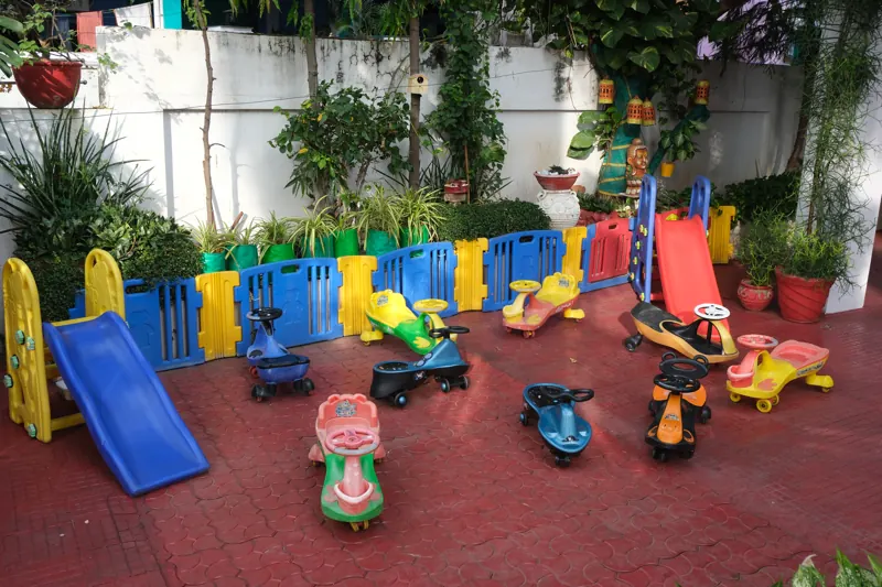 Outdoor play area with a slide and ride-on toys